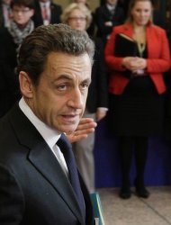 French President Nicolas Sarkozy arrives for an EU summit in Brussels on Thursday, Dec. 8, 2011. During a two-day summit German Chancellor Angela Merkel and French President Nicolas Sarkozy will try to build support for their plan for eurozone nations to submit their national budgets to much greater scrutiny. (AP Photo/Virginia Mayo)