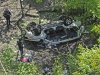 Police investigate the destroyed van that plunged over the Bronx River Parkway, Sunday April 29, 2012, in New York. Authorities say the out-of-control van plunged off a roadway near the Bronx Zoo, killing seven people, including three children. (AP Photo/ Louis Lanzano)