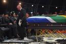 South Africa President Jacob Zuma returns to his seat after giving a speech during the funeral ceremony of Nelson Mandela in Qunu on December 15, 2013