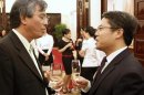 Vinh chats with Jiang during a reception to mark the 45th anniversary of the establishment of ASEAN in Hanoi