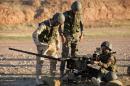 Kurdish Peshmerga fighters undergo training by British soldiers at a shooting range in Arbil