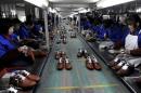 Employees work at a shoe factory in Lishui