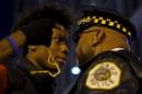 Protestors including Lamon Reccord, 16, confront police during a demonstration in response to the fatal shooting of Laquan McDonald in Chicago