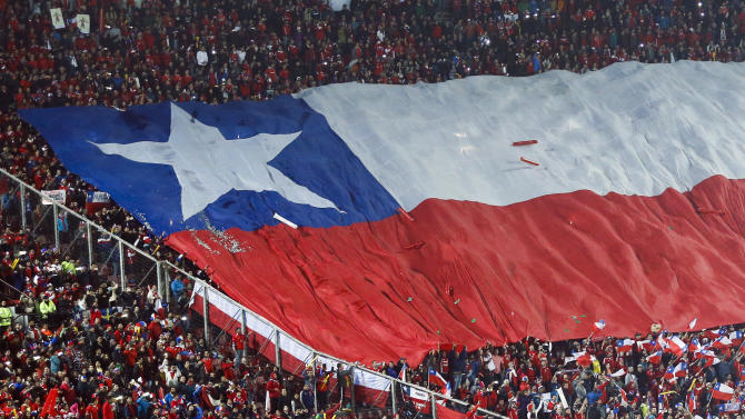 Fans hold a giant flag of Chile during a Copa America quarterfinal soccer match between Uruguay and Chile at the National Stadium in Santiago, Chile, Wednesday, June 24, 2015. (AP Photo/Silvia Izquierdo)
