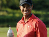 Tiger Woods poses with the trophy on the 18th green after winning the AT&T National golf tournament at Congressional Country Club in Bethesda, Md., Sunday, July 1, 2012. (AP Photo/Nick Wass)