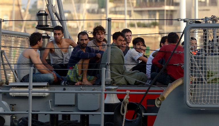 Migrants arrive at Hay Wharf in Valletta aboard a patrol boat of the Armed forces of Malta on October 12, 2013 a day after their boat sank