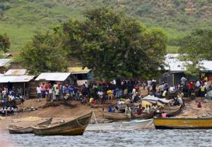 A general view shows the landing site where retrieved bodies are gathered after a boat carrying mostly Congolese refugees capsized at the shores of Lake Albert during rescue operations by the Uganda Marine Unit in Ntoroko