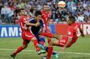 Japan's Yohei Toyoda is tackled by Palestine's Musab Battat, left, and Tamer Salah, right, during the AFC Asia Cup soccer match between Japan and Palestine in Newcastle, Australia, Monday, January 12, 2014. (AP Photo/Rob Griffith)