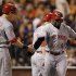 Cincinnati Reds' Brandon Phillips, right, gets congratulated by Drew Stubbs after Phillips hit a two-run home run in the third inning of Game 1 of the National League division baseball series against the San Francisco Giants in San Francisco, Saturday, Oct. 6, 2012. (AP Photo/Eric Risberg)