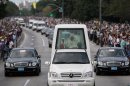 Pope Benedict XVI waves to people from his popemobile as he departs for the airport in Havana, Cuba, Wednesday March 28, 2012. (AP Photo/Ismael Francisco, Cubadebate)