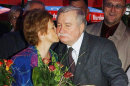 FILE - In this Sept. 30, 2003 file photo Lech Walesa, Poland's Solidarity leader and former president, gets a kiss from his wife Danuta, during a birthday party in Gdansk, Poland. Walesa, the democracy icon and Nobel peace prize winner, has sparked controversy and outrage in Poland by saying in a TV interview Friday, March 1, 2013, homosexuals have no right to a prominent role in politics and that as a minority they need to "adjust to smaller things" in society. (AP Photo/Czarek Sokolowski, File)