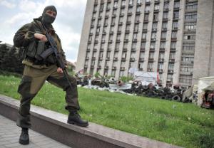 An armed pro-Russia militant stands guard near the …