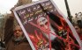 A demonstrator holds a crossed out poster depicting Iran's late leader Ayatollah Khomeini during a protest against Syria's President Bashar al-Assad, in Cairo