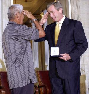 US President George W. Bush (R) salutes Navajo "code …