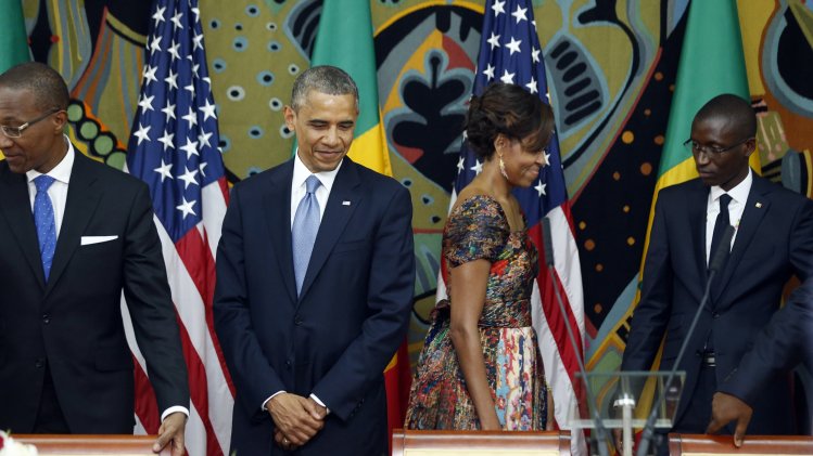 U.S. President Barack Obama and first lady Michelle Obama arrive at an official dinner with Senegal's President Macky Sall at the Presidential Palace in Dakar