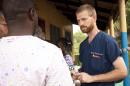 Handout photo of Dr. Kent Brantly speaking with colleagues at the case management center on the campus of ELWA Hospital in Monrovia, Liberia.