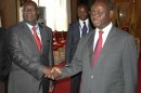 Leader of CAR's Seleka rebel alliance Djotodia shakes hands with CAR's President Bozize during peace talks in Libreville