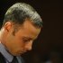 FILE - In this Feb. 21, 2013 file photo, Olympic athlete Oscar Pistorius stands during his bail hearing at the magistrate court in Pretoria, South Africa.Pistorius has been spending time with people who were close to the girlfriend he shot and killed on Valentine's Day, the Olympian's family said Thursday, April 11, 2013 in an indication that Pistorius is becoming more active while awaiting trial on a murder charge. (AP Photo/Themba Hadebe, File)