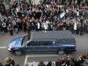 People pay their respects as the hearse carrying the casket of former Penn State football coach Joe Paterno passes through State College, Pa., Wednesday Jan. 25, 2012. Paterno died Sunday at the age of 85. (AP Photo/John Beale)