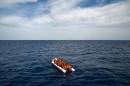Migrants and refugees on a rubber boat wait to be evacuated on November 5, 2016 off the coast of Libya