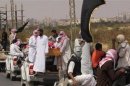 A funeral convoy carrying the bodies of four Islamist militants, drives through Sheikh Zuweid, in the north of the Sinai peninsula