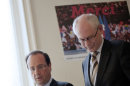 France's president-elect Francois Hollande, left, walks down stairs with European Council President Herman Van Rompuy after a meeting at his campaign headquarters in Paris, Wednesday, May 9, 2012. (AP Photo/Fred Dufour, Pool)