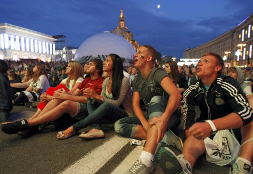 Soccer fans react as they watch the Euro 2012 semi-final soccer match between Germany and Italy at the fan zone in Kiev