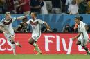 Germany's Mario Goetze, center, celebrates with Andre Schuerrle (9) after Goetze scored the opening goal during the World Cup final soccer match between Germany and Argentina at the Maracana Stadium in Rio de Janeiro, Brazil, Sunday, July 13, 2014. At right is Thomas Mueller (13). (AP Photo/Martin Meissner)