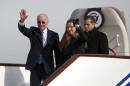 U.S. Vice President Biden waves as he walks out of Air Force Two with his granddaughter Biden and son Biden at the airport in Beijing