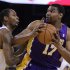 Los Angeles Lakers' Andrew Bynum, right, looks for a shot against Golden State Warriors' Mickell Gladness during the first half of an NBA basketball game Wednesday, April 18, 2012, in Oakland, Calif. (AP Photo/Ben Margot)