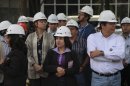Office workers wearing hard hats stand outside of a building that was evacuated after an earthquake was felt in Mexico City, Mexico, Monday April 2, 2012. Mexico was shaken Monday afternoon by a strong apparent aftershock from a powerful earthquake late last month. Officials said there were no immediate reports of serious damage or injuries from the quake, which had an initial magnitude of 6.3. (AP Photo/Dario Lopez-Mills)