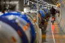 A worker rides his bicycle in a tunnel of the European Organisation for Nuclear Research (CERN) Large Hadron Collider (LHC), during maintenance works on July 19, 2013 in Meyrin, near Geneva