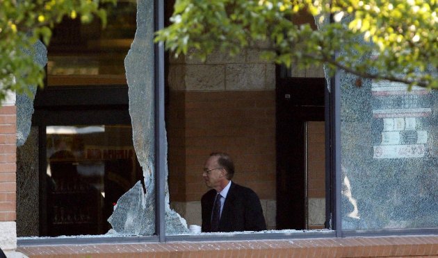 Middlesex County prosecutor Bruce Kaplan inspects the scene of a shooting at a Pathmark grocery store in Old Bridge, N.J., Friday, Aug. 31, 2012. An employee of the supermarket opened fire at the closed store early Friday as a dozen or more colleagues worked inside, killing two of them and himself, Kaplan said. (AP Photo/Julio Cortez)