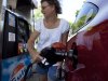 FILE - In this July 10, 2012 file photo, Suzanne Meredith, of Walpole, Mass., gases up her car at a Gulf station in Brookline, Mass. Reducing sulfur in gasoline and tightening emissions standards on cars beginning in 2017, as the Obama administration is proposing, would come with costs as well as rewards. (AP Photo/Steven Senne, File)