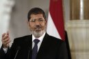 FILE - In this Friday, July 13, 2012 file photo, Egyptian President Mohammed Morsi speaks to reporters during a joint news conference with Tunisian President Moncef Marzouki, unseen, at the Presidential palace in Cairo, Egypt. An Egyptian presidential official said Saturday, Aug. 18, 2012 that President Mohammed Morsi will attend a summit of non-aligned nations in Iran end of the month, in first such visit in decades.(AP Photo/Maya Alleruzzo, File)