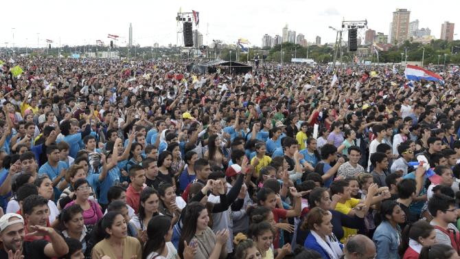 People wait for the arrival of Pope Francis at the 