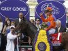 Jockey Garrett Gomez, atop Beholder, celebrates in the winner's circle after the running of the Breeders' Cup Grey Goose Juvenile Fillies thoroughbred horse race at Santa Anita Park in Arcadia