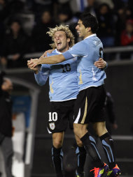 Uruguay's Luis Suarez, right, celebrates with teammate Diego Forlan after scoring his team's second goal during a Copa America semifinal soccer match against Peru in La Plata, Argentina, Tuesday, July 19, 2011. (AP Photo/Eduardo Di Baia)