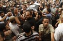 Palestinians carry the body of militant Basil Ahmed during his funeral in the Gaza Strip