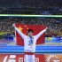 China's Sun Yang raises his national flag to spectators after winning the gold medal in the men's 1,500m Freestyle event at the FINA Swimming World Championships in Shanghai, China, Sunday, July 31, 2011. (AP Photo/Eugene Hoshiko)