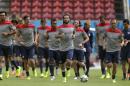 United States' Kyle Beckerman, center, jogs with teammates during a training session in Recife, Brazil, Wednesday, June 25, 2014. The United States will play Germany in group G of the 2014 soccer World Cup on June 26. (AP Photo/Julio Cortez)