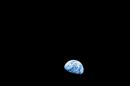 NASA handout image shows the distant blue Earth above the Moon's limb