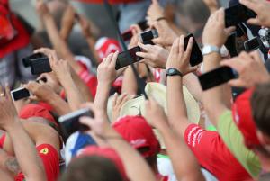 Spectators take photos with their smartphones at the&nbsp;&hellip;