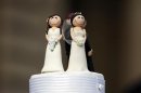 Two bride figurines adorn the top of a wedding cake during an illegal same-sex wedding ceremony in central Melbourne