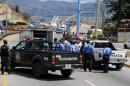 National Police agents surround the vehicle in which the deputy director of the "Marco Aurelio Soto" National Penitentiary, Juan Andres Sanchez, traveled when he was riddled with bullets in Tegucigalpa on March 11, 2016