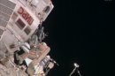 In this image from video made available by NASA, cosmonaut Fyodor Yurchikhin approaches a hatch on the International Space Station, about 7 hours into a spacewalk with Aleksandr Misurkin on Friday, Aug, 16, 2013. The Russians rigged cable outside the station for a new lab that's due to arrive in a few months. (AP Photo/NASA)