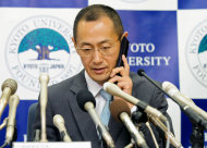Kyoto University Professor Shinya Yamanaka receives a call from Japanese Prime Minister Toshihiko Noda to congratulate his winning of Nobel Prize during a news conference at Kyoto University in Kyoto, Japan, Monday night, Oct. 8, 2012. Yamanaka and British researcher John Gurdon won this year's Nobel Prize in physiology or medicine. (AP Photo/Kyodo News) JAPAN OUT, MANDATORY CREDIT, NO LICENSING IN CHINA, FRANCE, HONG KONG, JAPAN AND SOUTH KOREA