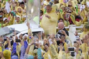 Pope Francis waves to pilgrims after holding a mass …