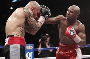 Floyd Mayweather Jr. lands a punch against Miguel Cotto. (AP)