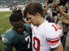 Philadelphia Eagles' Michael Vick, left, shows his hand to New York Giants' Eli Manning after an NFL football game on Sunday, Sept. 25, 2011, in Philadelphia. Vick left with a broken right hand in the fourth quarter and New York won 29-16. (AP Photo/Matt Slocum)